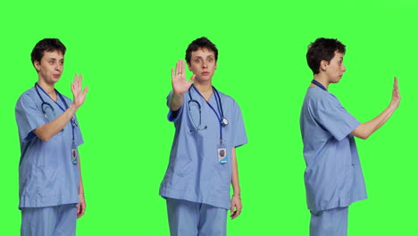 Health-specialist-with-blue-scrubs-showing-stop-sign-in-studio